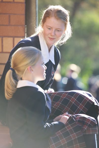 Two girls talking in the sun.JPG